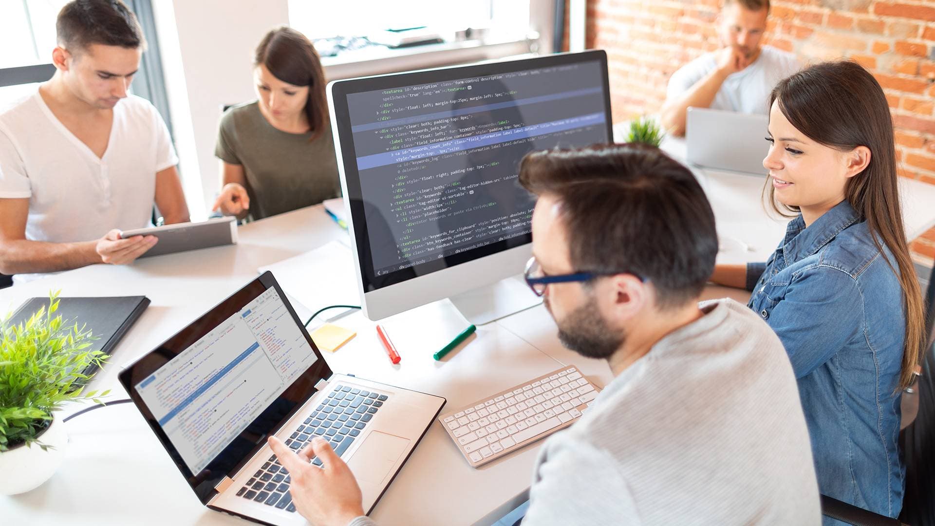 A group of young people working together in a modern office