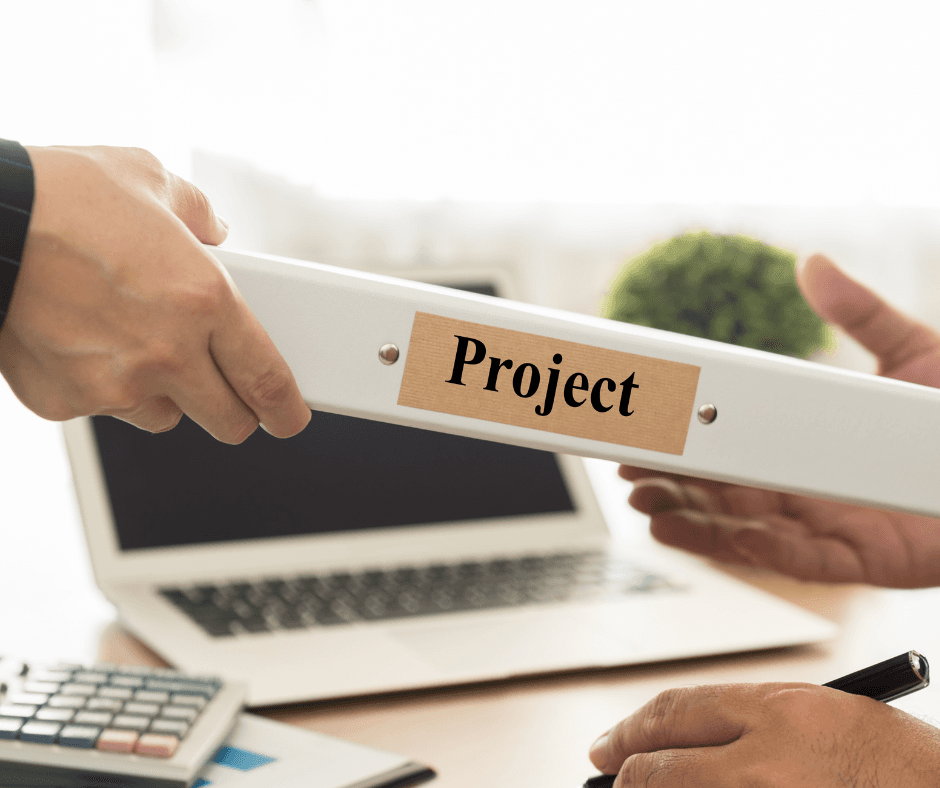 The person handing the folder labeled "Project" to the other person over the desk, which ugerates the exchange of project documentation or the transfer of the project