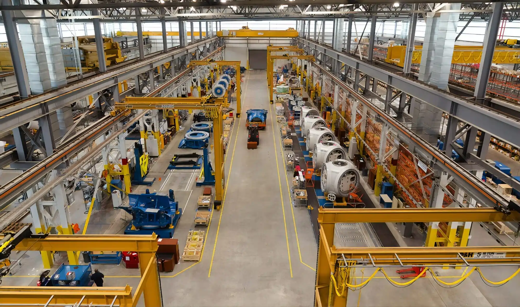 Top view of a modern manufacturing plant with assembly lines and advanced industrial equipment.